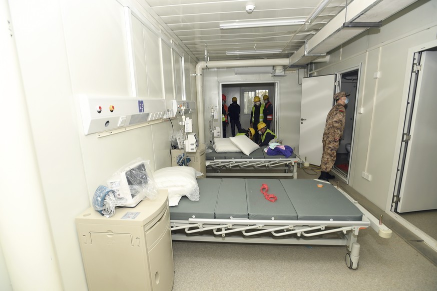 A Chinese army medic looks at a patient room at the Huoshenshan temporary field hospital in Wuhan in central China&#039;s Hubei Province, Sunday, Feb. 2, 2020. The Philippines on Sunday reported the f ...