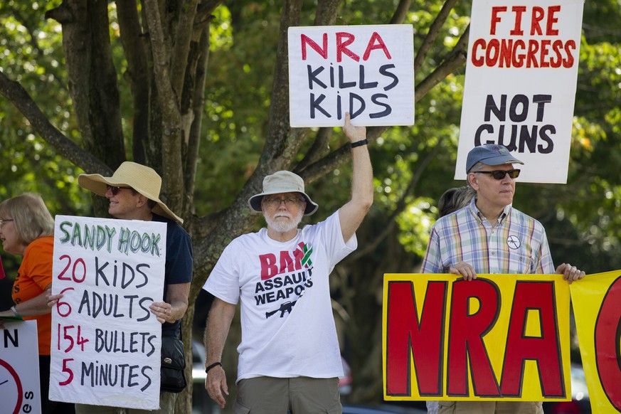 epa07773492 Supporters of gun control reform protest against the National Rifle Association (NRA) at the NRA headquarters in Fairfax, Virginia, USA, 14 August 2019. There has been a renewed call for g ...