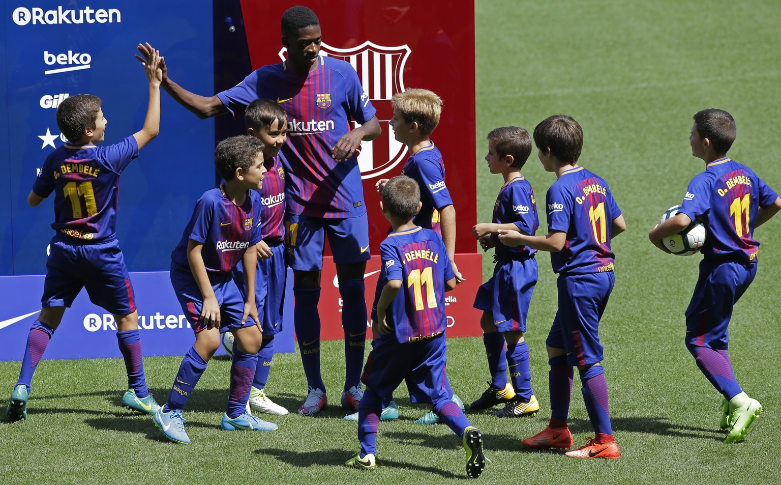 EDS NOTE : SPANISH LAW REQUIRES THAT THE FACES OF MINORS ARE MASKED IN PUBLICATIONS WITHIN SPAIN - FC Barcelona&#039;s new player Ousmane Dembele shakes hands with children during his official present ...