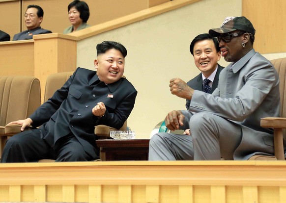 In this Jan. 8, 2014 photo provided by the North Korean government, North Korean leader Kim Jong Un, left, talks with former NBA player Dennis Rodman, right, as they watch an exhibition basketball gam ...
