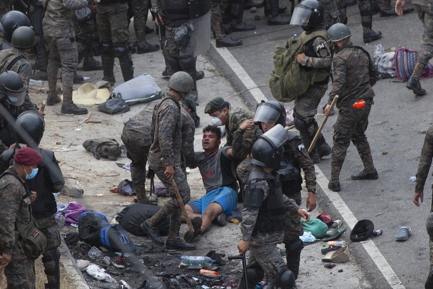 A Honduran migrant is tended to by Guatemalan soldiers after they clashed with them in a bid to reach the U.S. border in Vado Hondo, Guatemala, Sunday, Jan. 17, 2021. Guatemalan authorities estimated  ...