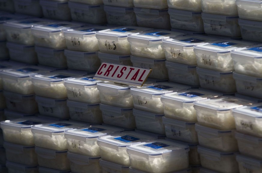 Plastic containers of crystal meth sit on display for the media in Tijuana, Mexico, Tuesday March 15, 2011. According to the army, 95 packages of cocaine, 396 plastic containers of crystal meth and th ...