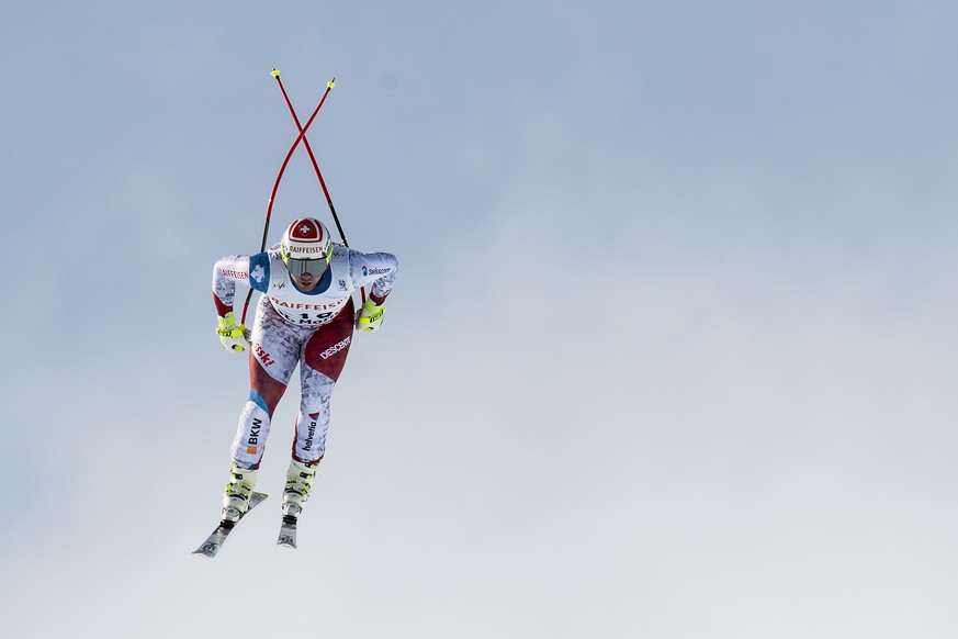 Beat Feuz of Switzerland is airborne during the men downhill race at the 2017 FIS Alpine Skiing World Championships in St. Moritz, Switzerland, Sunday, February 12, 2017. (KEYSTONE/Jean-Christophe Bot ...