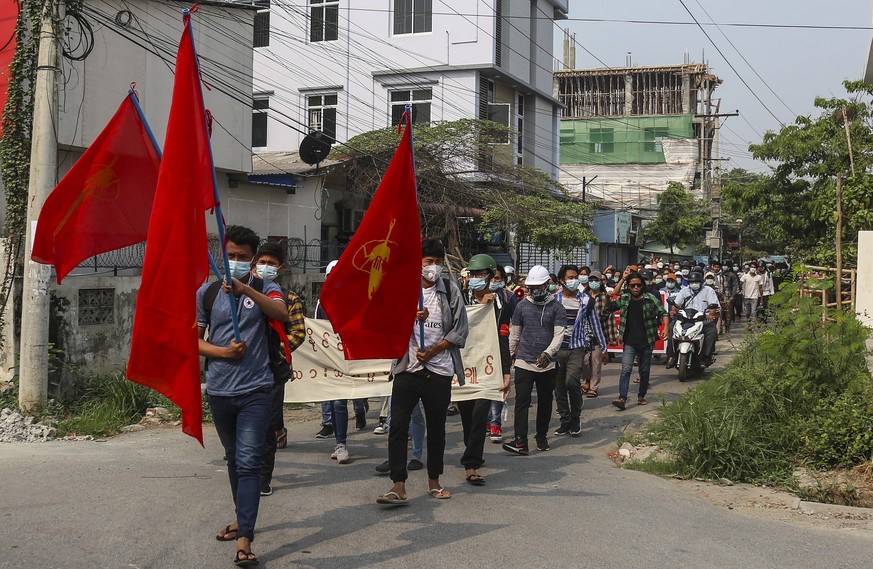 epa09105861 Demonstrators march during a protest against the military coup in Mandalay, Myanmar, 30 March 2021. Anti-coup protests continued in Myanmar as more than 500 people were reportedly killed i ...