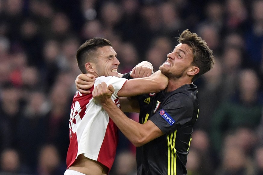 Ajax&#039;s Dusan Tadic, left, fights for the ball with Juventus&#039; Daniele Rugani during the Champions League quarterfinal, first leg, soccer match between Ajax and Juventus at the Johan Cruyff Ar ...