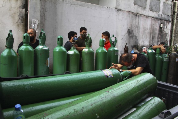 Family members of patients hospitalized with COVID-19 line up with empty oxygen tanks in an attempt to refill them, outside the Nitron da Amazonia company, in Manaus, Amazonas state, Brazil, Friday, J ...