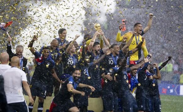 France players hold up the World Cup trophy at the end of the final match between France and Croatia at the 2018 soccer World Cup in the Luzhniki Stadium in Moscow, Russia, Sunday, July 15, 2018. Fran ...