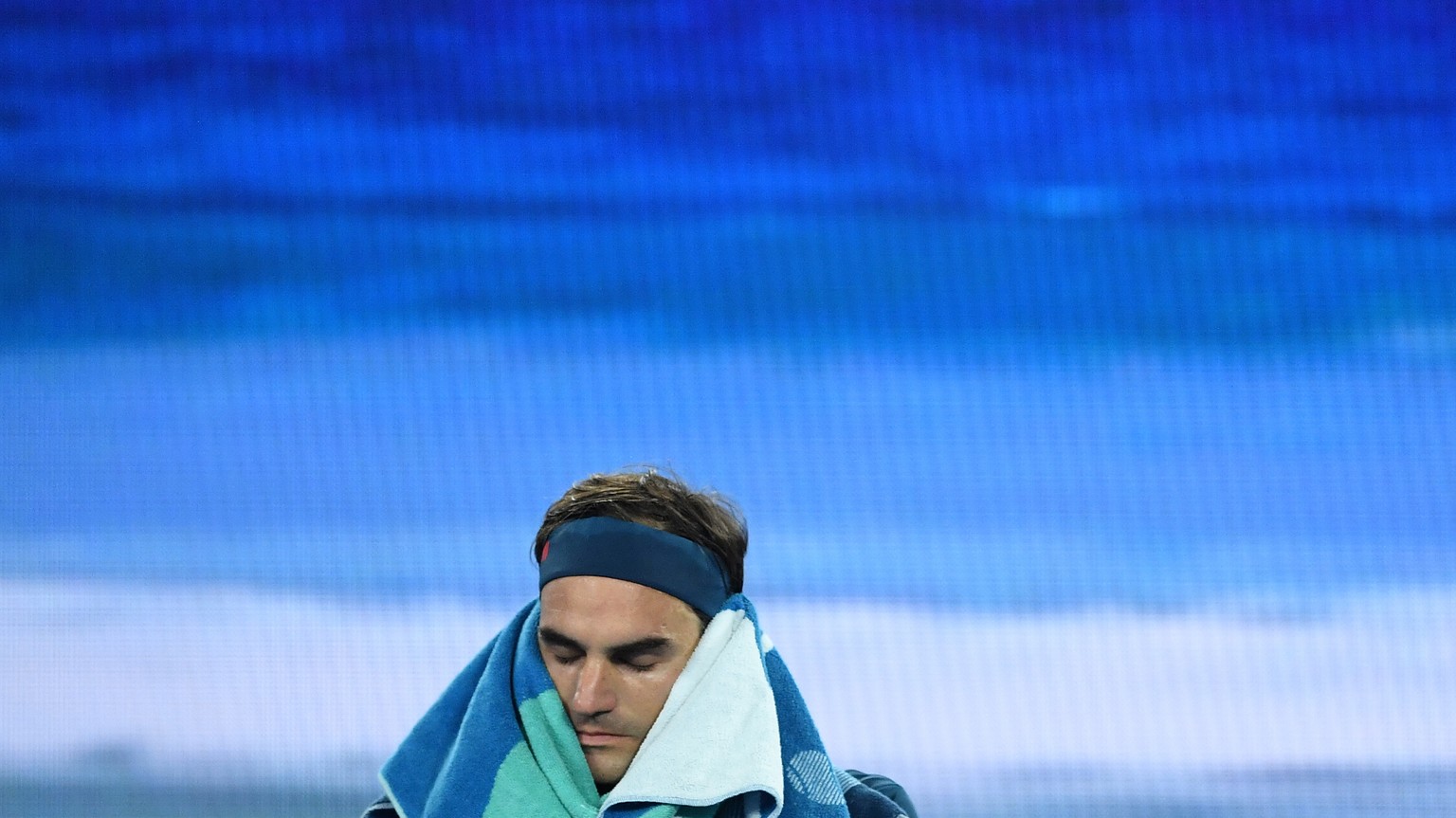 epa07295043 Roger Federer of Switzerland takes a break during action against Taylor Fritz of the USA during their round three men&#039;s singles match at the Australian Open Grand Slam tennis tourname ...