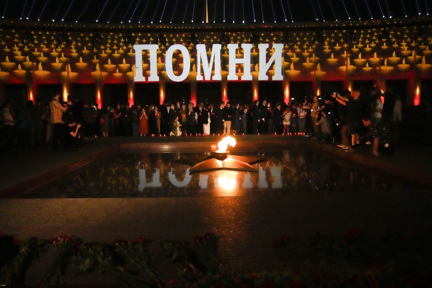 People light candles marking the 80th anniversary of the Nazi invasion of the Soviet Union at the World War II museum on Poklonnaya Hill in Moscow, Russia, early Tuesday, June 22, 2021. The word in th ...