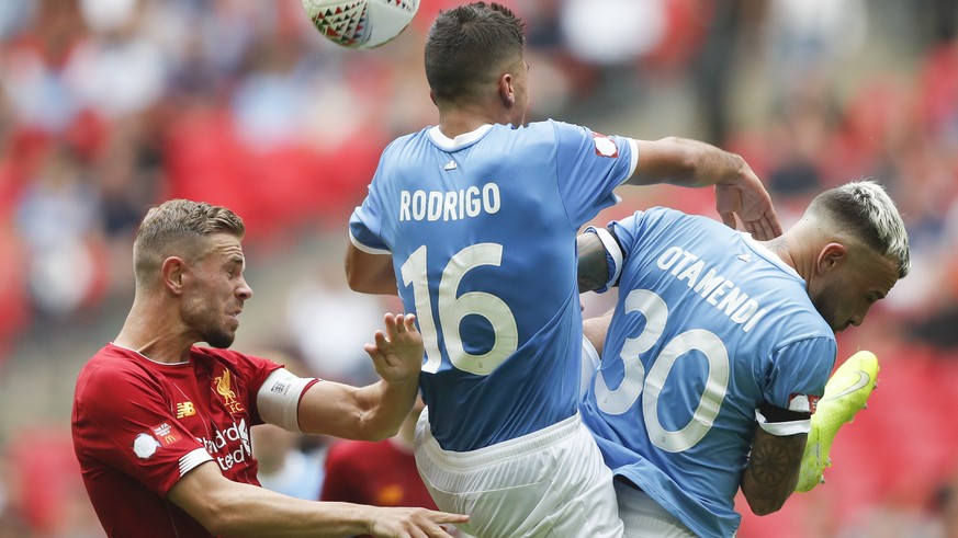 Liverpool&#039;s Jordan Henderson, left, vies for the ball with Manchester City&#039;s Rodrigo, centre, and Manchester City&#039;s Nicolas Otamendi during the Community Shield soccer match between Man ...