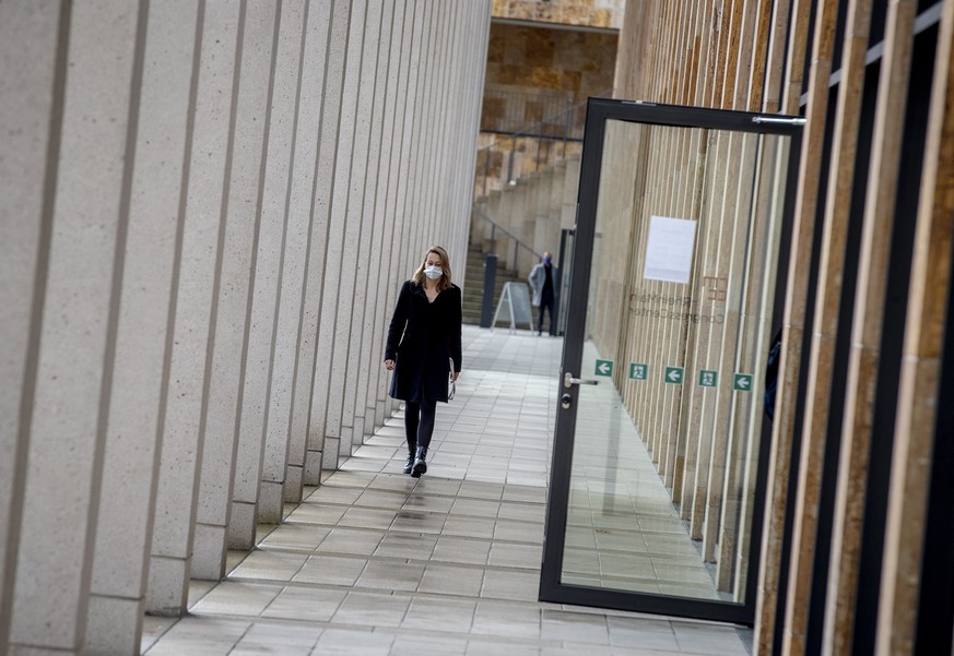 A woman walks towards the entrance of a vaccine center that was introduced to the media in Wiesbaden, Germany, Monday, Dec. 7, 2020. The vaccine center will start its business as soon as the vaccine w ...