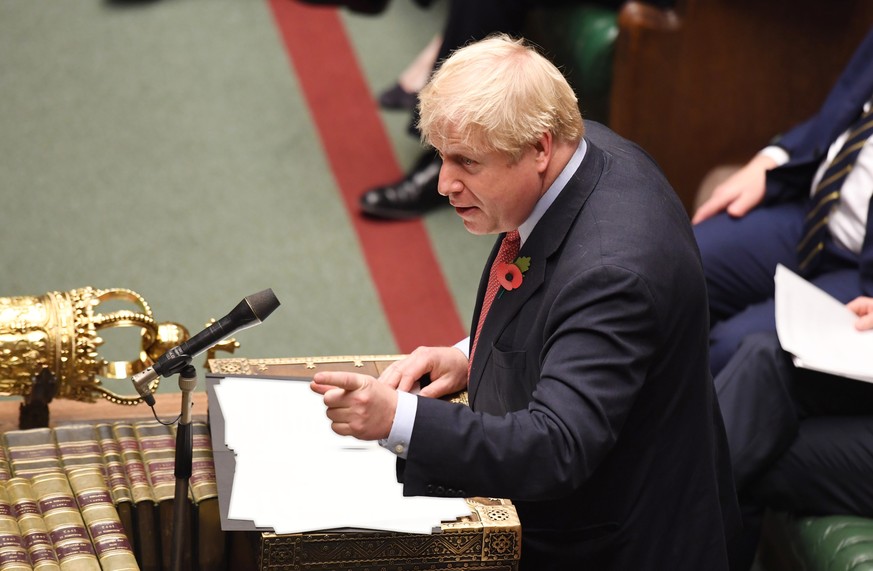 epa07958512 A handout photo made available by the UK Parliament shows the British Prime Minister, Boris Johnson speaking during a debate of the Early Parliamentary General Election Bill in during an e ...
