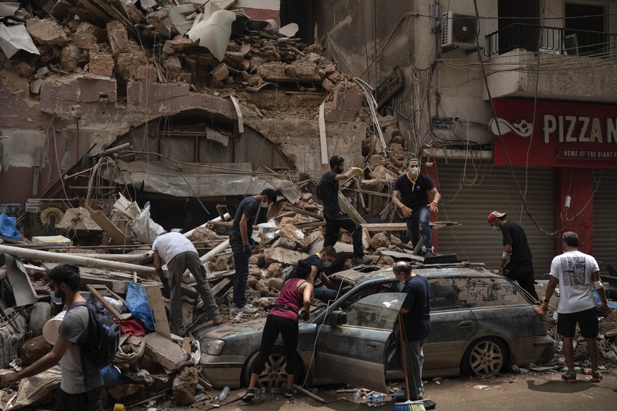 People remove debris from a house damaged by Tuesday&#039;s explosion in the seaport of Beirut, Lebanon, Friday, Aug. 7, 2020. Rescue teams were still searching the rubble of Beirut&#039;s port for bo ...