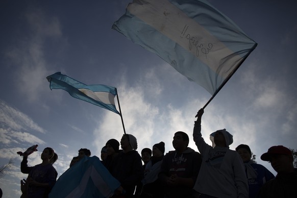 Argentina soccer fans wave flags as they wait for the arrival of Argentina&#039;s team to the airport in Buenos Aires, Argentina, Monday, July 14, 2014. Fans came out to welcome home Argentina&#039;s  ...