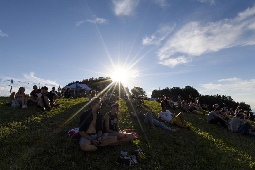 Festival goers relax in the grass during the 35th edition of the Gurten music open air festival in Bern, Switzerland, this Thursday, July 12, 2018. The open air music festival runs from 11 to 14 July. ...