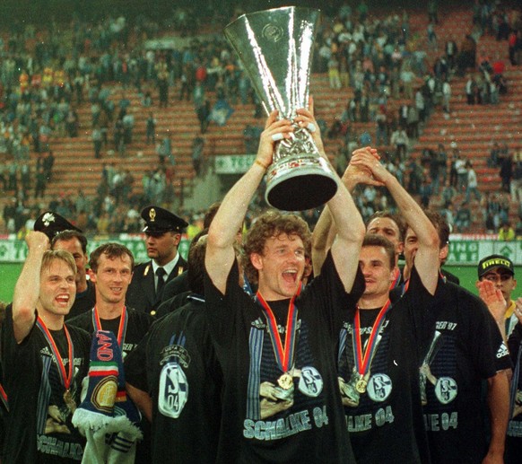 FILE - In this May 22, 1997 file photo Schalke 04 goalkeeper Jens Lehmann holds the UefA Cup, while his teammates celebrate after beating Internazionale of Milan 4 - 1 in the penalty shootout at Milan ...