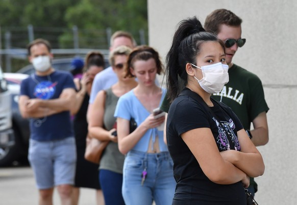 epa08320230 People line up at the Coorparoo pre-polling booth for the Brisbane City Council elections in Brisbane, Australia, 25 March 2020. Queensland&#039;s local government elections are due to be  ...