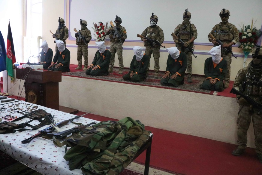 epa09244603 Afghan security officials show suspected militants to media, in Herat, Afghanistan, 03 June 2021. At least six suspected militants were captured during a special operation by national secu ...