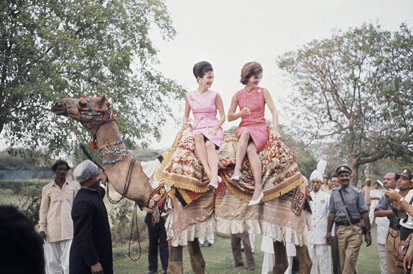 Mrs. Jacqueline Kennedy, the widely traveled wife of Pres. John F. Kennedy, right, perches on camel with her is her sister, Princess Lee Radziwill March 1, 1962, Karachi, Pakistan. Mrs. Kennedy was on ...
