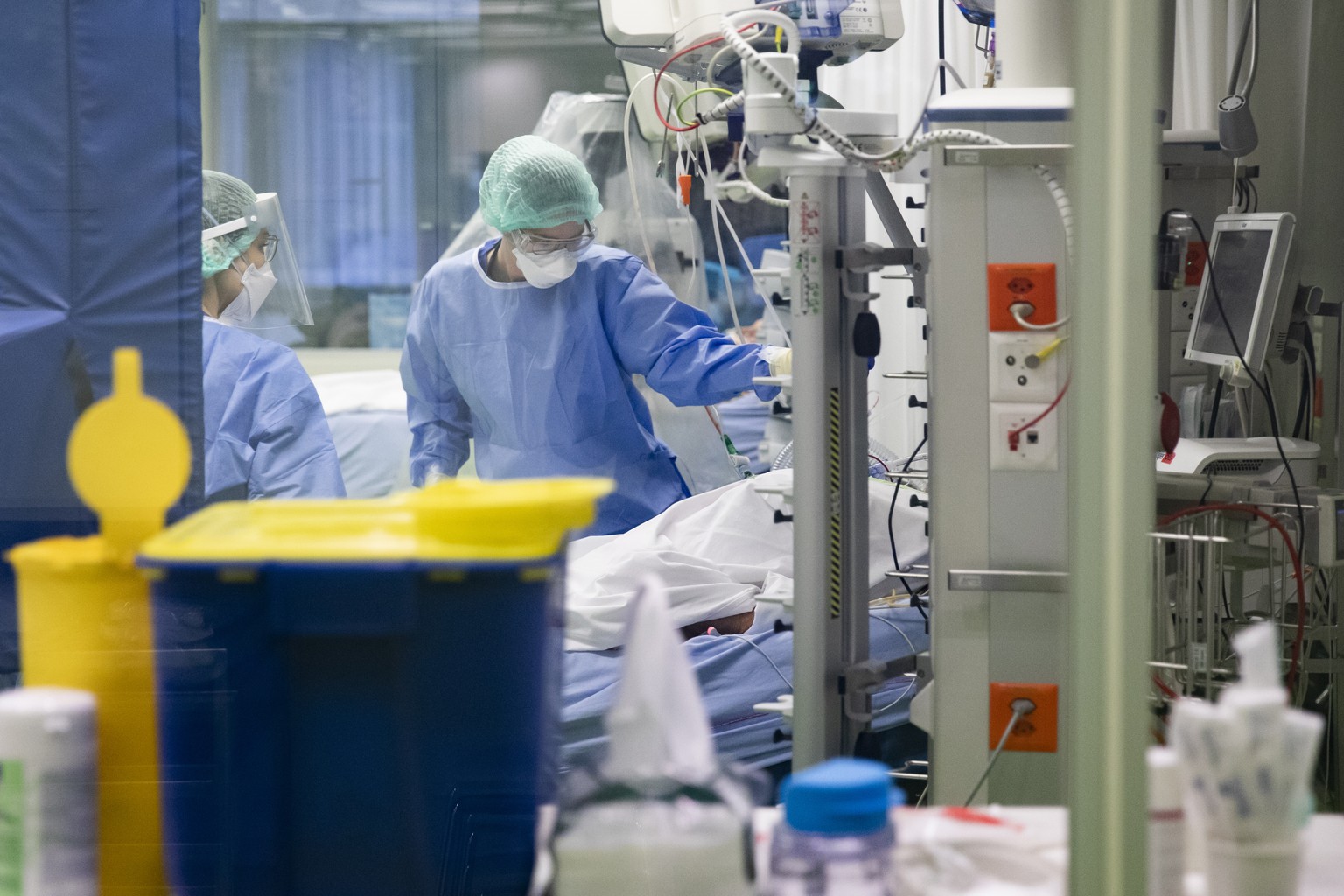 Aerzte und Pflegende kuemmern sich um Covid-Patienten in einer Intensivstation im Universitaetsspital Basel, am Montag, 28. Dezember 2020, in Basel. (KEYSTONE/Peter Klaunzer)