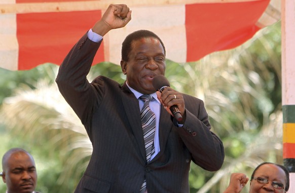FILE -- In this Wednesday Feb. 10, 2016 file photo, Zimbabwean Deputy President Emmerson Mnangagwa greets party supporters at the ZANU-PF headquarters in Harare. Zimbabwean President Robert Mugabe on  ...