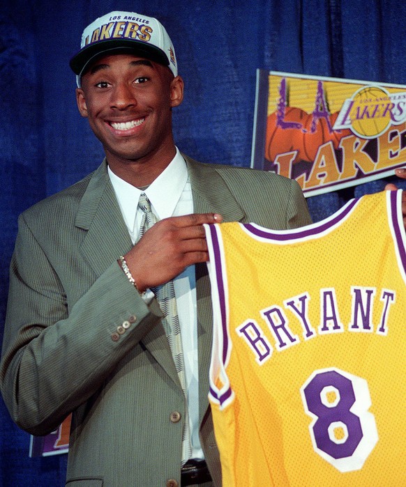 FILE - In this July 12, 1996 file photo Kobe Bryant, 17, jokes with the media as he holds his Los Angeles Lakers jersey during a news conference at the Great Western Forum in Inglewood, Calif. Bryant, ...