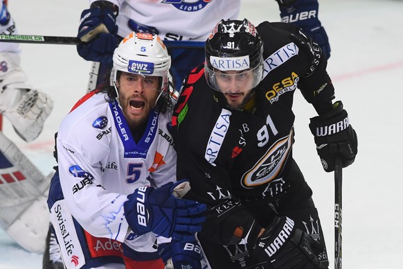 Zurich&#039;s player Severin Blindenbacher, left, fight for the puck with Lugano&#039;s player Julian Walker, right, during the preliminary round game of National League Swiss Championship 2018/19 bet ...