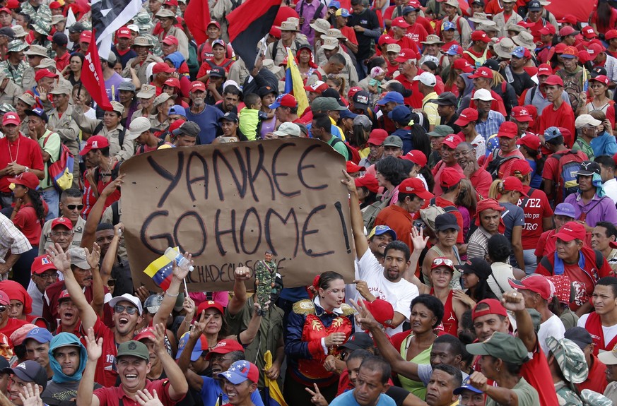 Supporters of President Nicolas Maduro hold up an anti-American banner during a rally in Caracas, Venezuela, Saturday, Feb. 2, 2019. Maduro called the rally to celebrate the 20th anniversary of the la ...