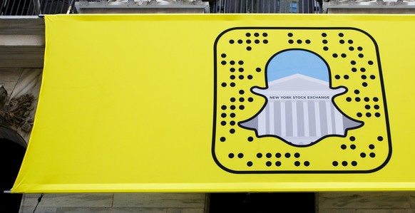 epa05635065 A logo for Snapchat hangs on the front of the New York Stock Exchange in New York, New York, USA, on 17 November 2016. Snap Inc., the parent company of Snapchat, has filed for an initial p ...