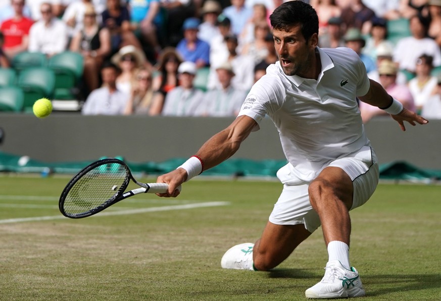 epa07697512 Novak Djokovic of Serbia in action against Hubert Hurkacz of Poland during their third round match at the Wimbledon Championships at the All England Lawn Tennis Club, in London, Britain, 0 ...