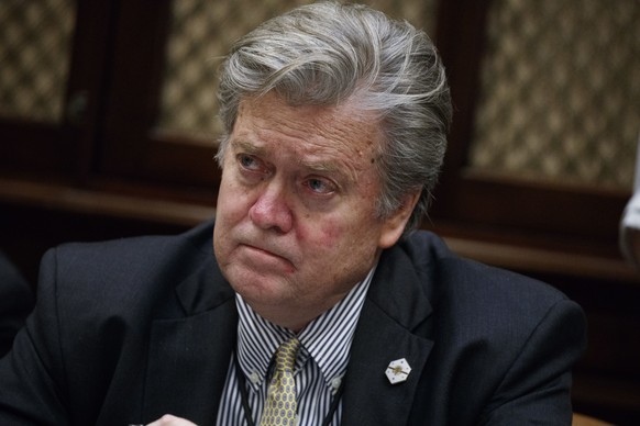 FILE - In this Feb. 7, 2017 file photo, White House chief strategist Steve Bannon listens as President Donald Trump speaks during a meeting with county sheriffs in the Roosevelt Room of the White Hous ...