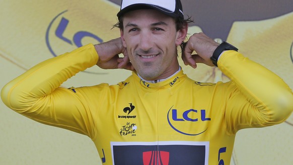 Switzerland&#039;s Fabian Cancellara adjusts the overall leader&#039;s yellow jersey on the podium of the second stage of the Tour de France cycling race over 166 kilometers (103 miles) with start in  ...