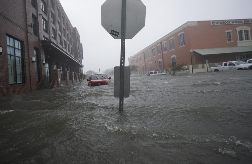 Flood waters move on the street, Wednesday, Sept. 16, 2020, in downtown Pensacola, Fla. Hurricane Sally made landfall Wednesday near Gulf Shores, Alabama, as a Category 2 storm, pushing a surge of oce ...