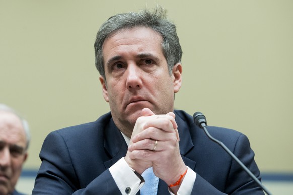 epa07402713 Michael Cohen, former attorney to US President Donald J. Trump, reacts while listening to the closing remarks of House Oversight and Reform Committee Chairman Elijah Cummings, while appear ...