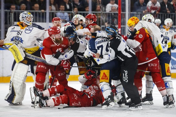 Lausanne&#039;s players (red) fight against Zug&#039;s players, during the third leg of the playoffs semifinal game of National League A (NLA) Swiss Championship between Lausanne HC and EV Zug, at the ...