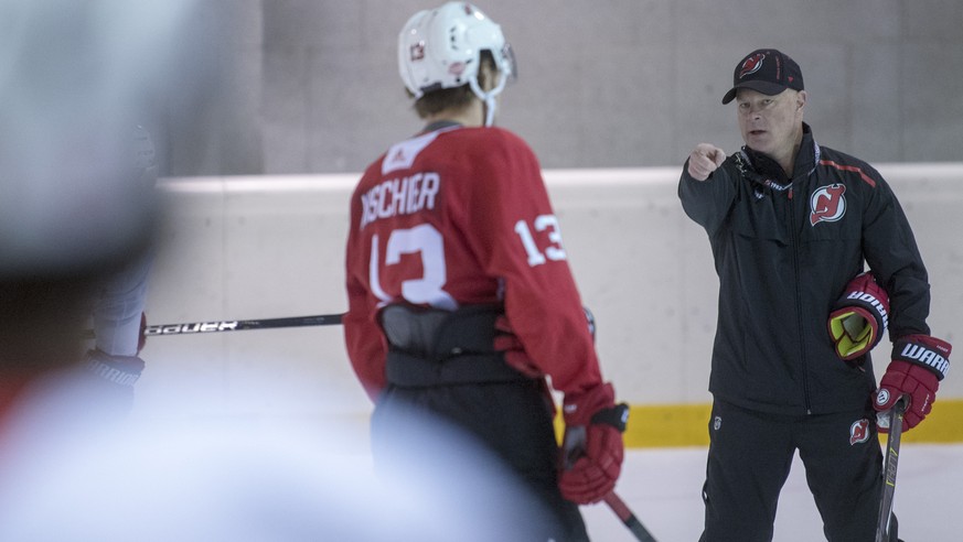 New Jersey Devils Swiss player Nico Hischier, left, listens to his head coach John Hynes during the training at the Postfinance Arena in Bern, Switzerland, Sunday, September 30, 2018. The New Jersey D ...