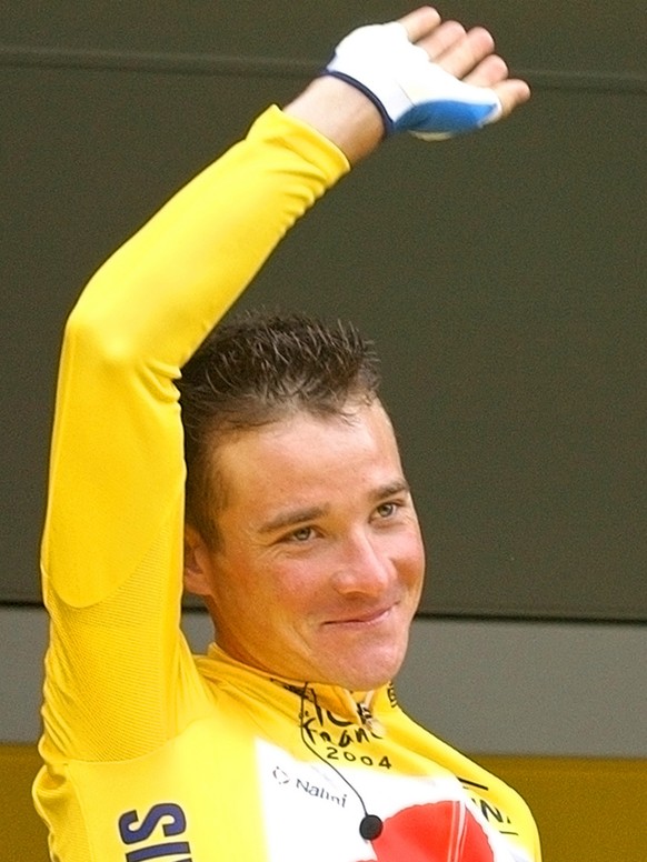 Overall leader Thomas Voeckler of France, wearing the yellow jersey, waves from the registration podium prior to the start of the 6th stage of the Tour de France cycling race between Bonneval and Ange ...