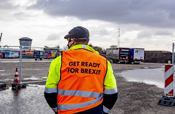 epa08854771 A campaigner wearing a vest stands at a erminal of a ferry operator in the port of Rotterdam, The Netherlands, 01 December 2020, as part of the Get Ready For Brexit campaign. As a result o ...
