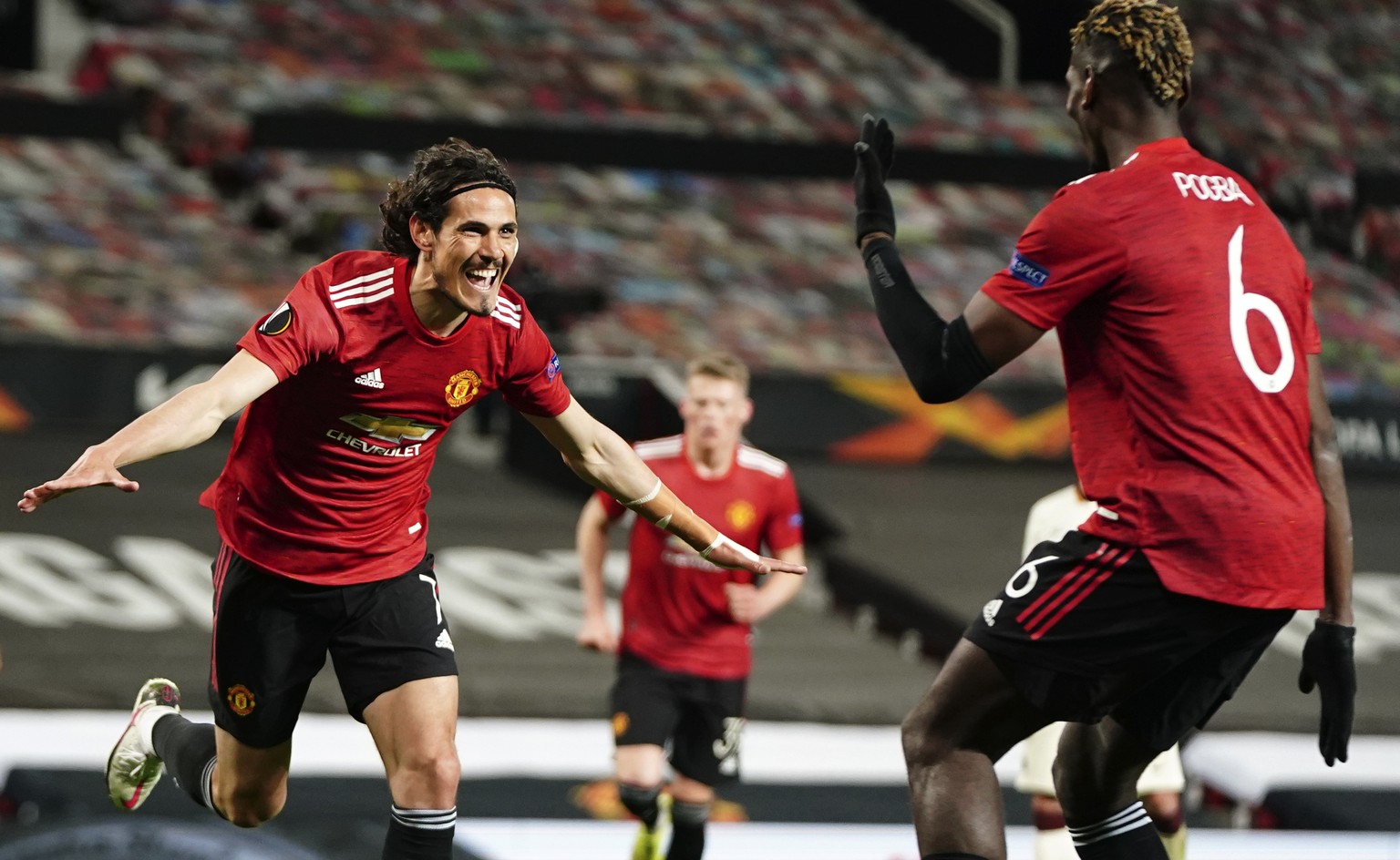 Manchester United&#039;s Edinson Cavani, left, celebrates after scoring his side&#039;s third goal during the Europa League semi final, first leg soccer match between Manchester United and Roma at Old ...