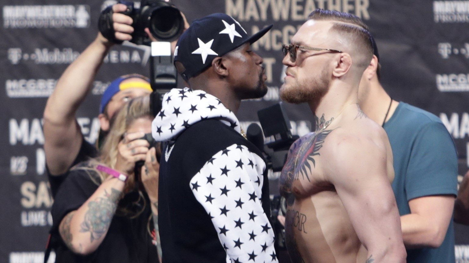 In this July 13, 2017, file photo, Floyd Mayweather Jr., left, and Conor McGregor, of Ireland, face each other for photos during a news conference at Barclays Center in New York. Nevada boxing regulat ...