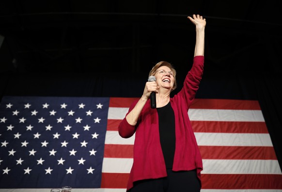 Sen. Elizabeth Warren, D-Mass, waves to the crowd during an organizing event at Curate event space in Des Moines, Iowa, Saturday, Jan. 5, 2019. (AP Photo/Matthew Putney)