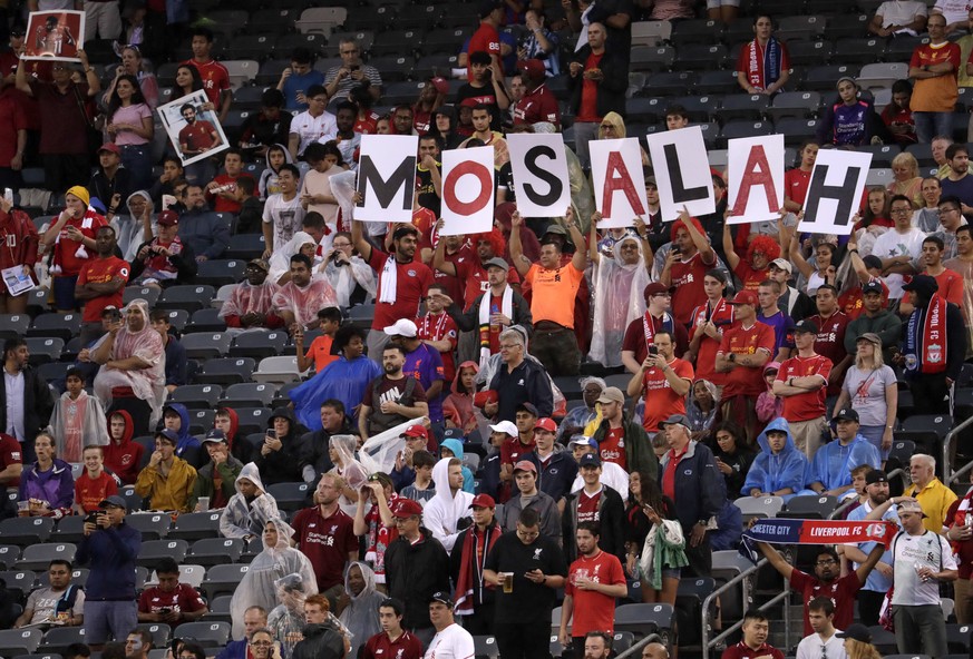 Supporters of Liverpool midfielder Mohamed Salah hold signs prior to an International Champions Cup tournament soccer match between the Manchester City and the Liverpool, Wednesday, July 25, 2018, in  ...