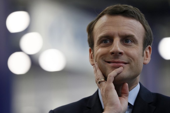 French presidential election candidate for the En Marche ! movement Emmanuel Macron reacts during his visit at the KRYS group&#039;s headquarters in Bazainville, near Paris Tuesday April 18, 2017. The ...