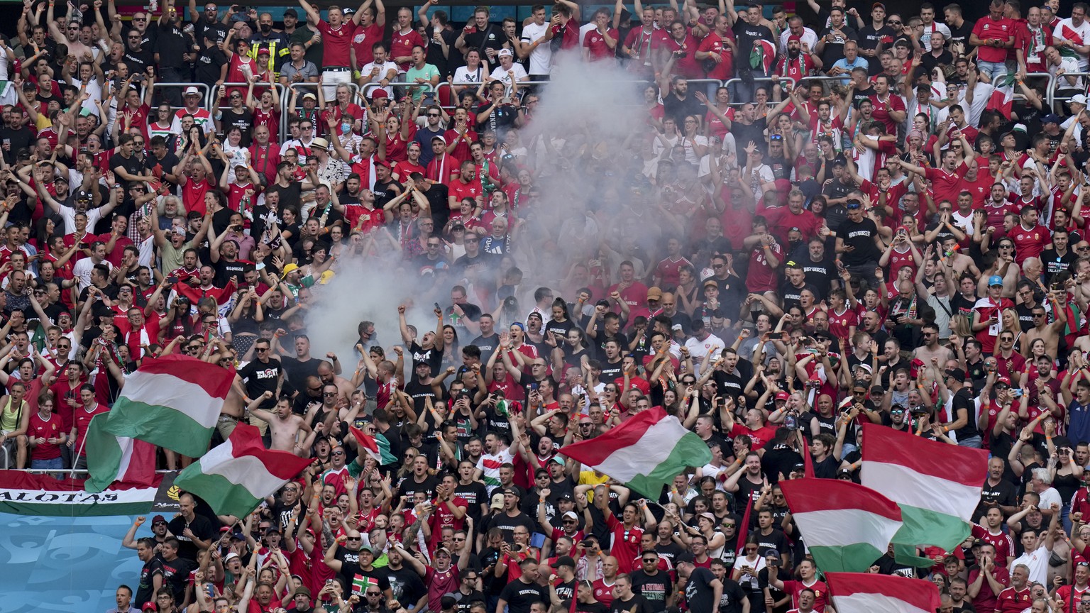 Hungarian fans celebrate after Attila Fiola scored his side&#039;s opening goal, during the Euro 2020 soccer championship group F match between Hungary and France, at the Ferenc Puskas stadium in Buda ...