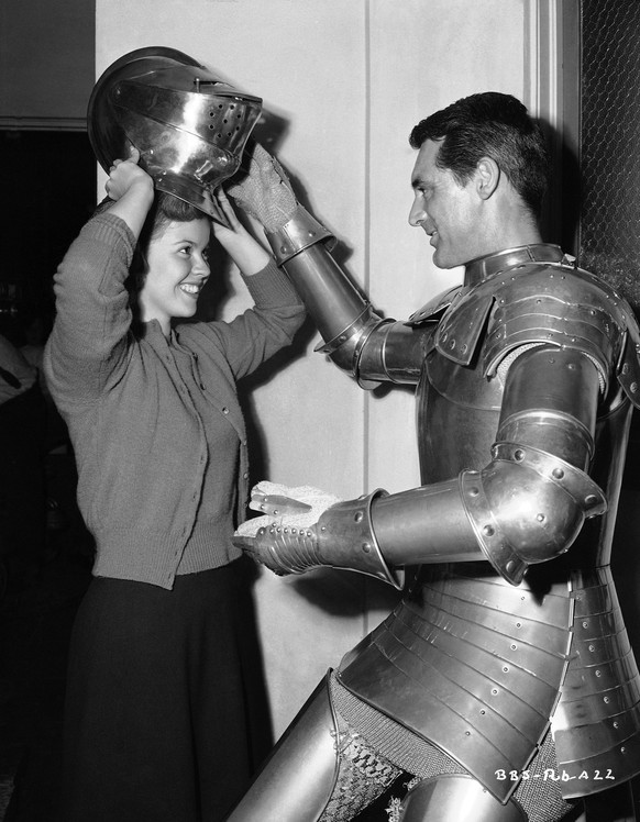 Cary Grant is dressed as a knight while shooting a scene for &quot;The Bachelor and the Bobby-Soxer&quot; in Hollywood on August 16, 1946. Shirley Temple visited the set and tried Grant&#039;s helmet  ...