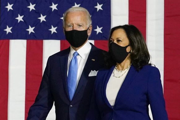 Democratic presidential candidate former Vice President Joe Biden and his running mate Sen. Kamala Harris, D-Calif., arrive to speak at a news conference at Alexis Dupont High School in Wilmington, De ...