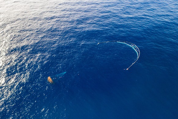 epa07892093 A handout photo made available by The Ocean Cleanup shows the company&#039;s ocean cleanup prototype System 001/B with its parachute configuration capturing plastic debris in the Great Pac ...