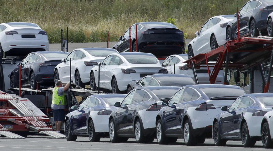Tesla cars are loaded onto carriers at the Tesla electric car plant Wednesday, May 13, 2020, in Fremont, Calif. A dispute between Tesla and San Francisco Bay Area authorities over the reopening of a f ...