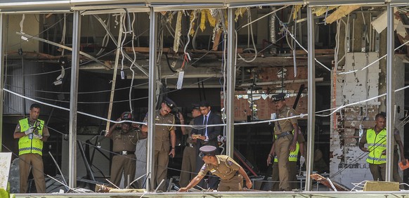 A Sri Lankan Police officer inspects a blast spot at the Shangri-la hotel in Colombo, Sri Lanka, Sunday, April 21, 2019. More than hundred were killed and hundreds more hospitalized with injuries from ...