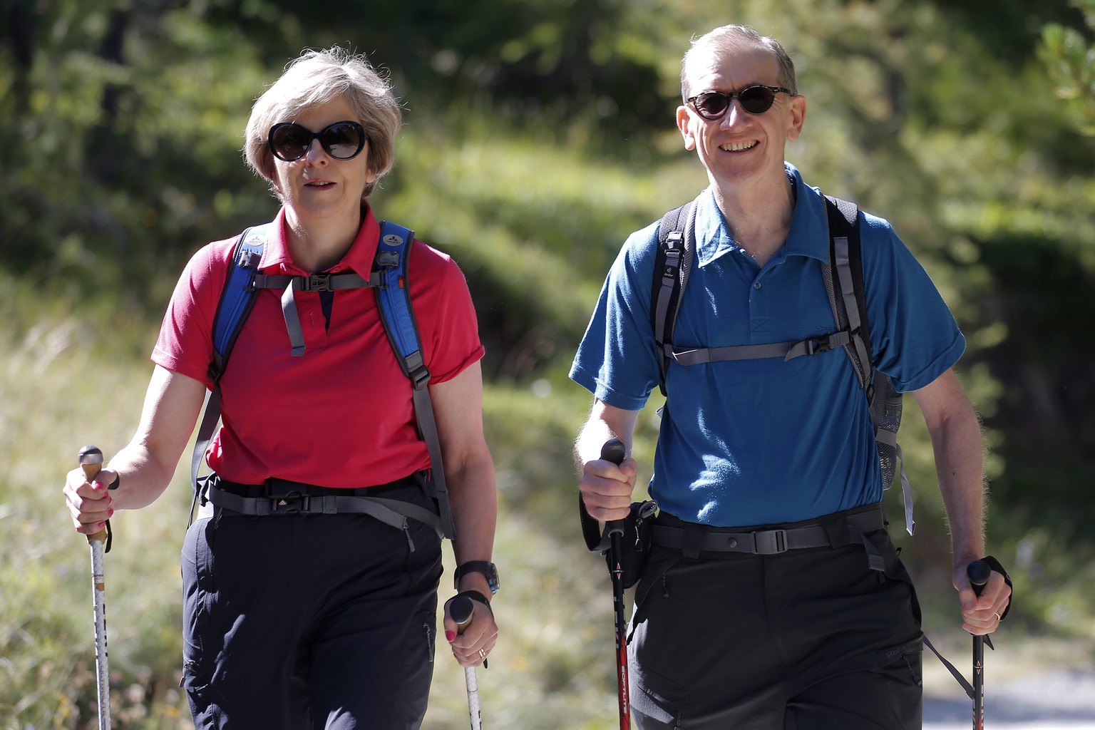 British Prime Minister Theresa May, walks in a forest with her husband Philip at the start of a summer holiday in the Alps in Switzerland on Friday Aug. 12, 2016. (Marco Bertorello/Pool via AP)